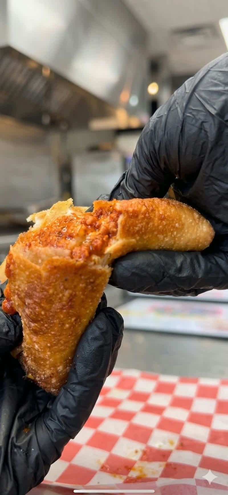 A freshly cooked chicken wing in Kay’s kitchen